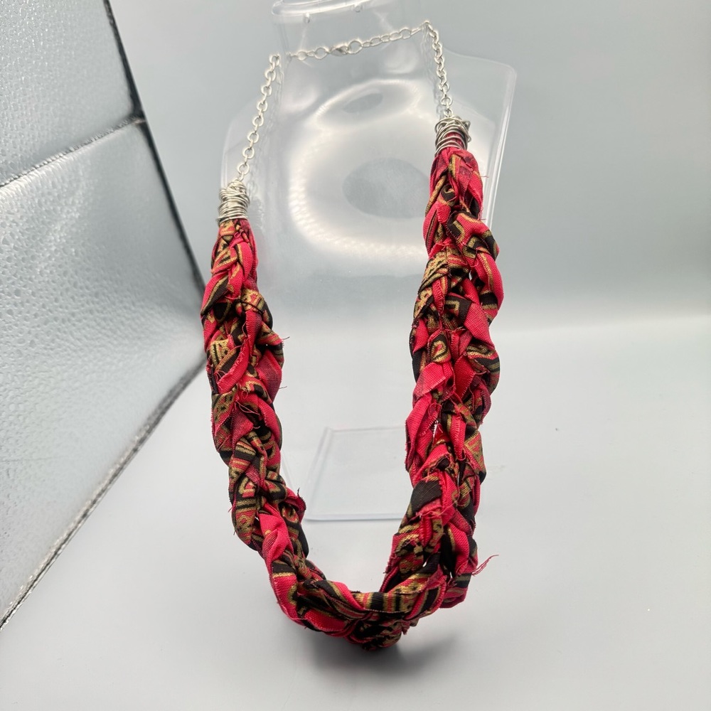 Gargantilla de tela color roja con negro y dorado y una verde negro y dorado